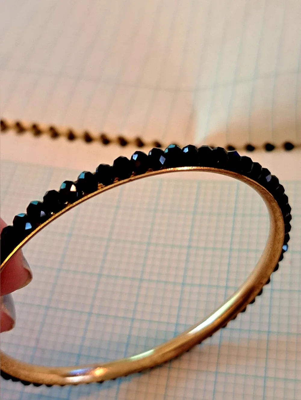 Gold-Tone Eternity Bangle Bracelet with Black Crystal Row